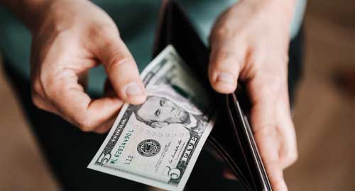 Person pulling money out of wallet.