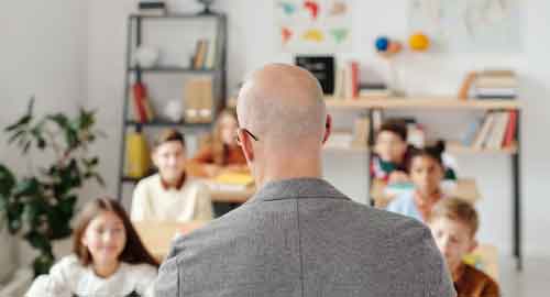 Teacher teaching a class of children.