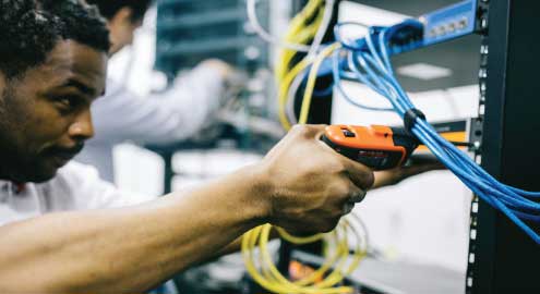 Man working with network cabling.